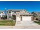 Charming two-story home with a well-maintained lawn, a three car garage and classic architectural details at 18995 E Bellisario Creek Pl, Parker, CO 80134