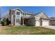 Attractive two-story home with three-car garage, well-maintained lawn, and neutral toned exterior at 18995 E Bellisario Creek Pl, Parker, CO 80134