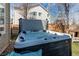 Close-up of a luxurious hot tub, perfect for relaxation, set in a backyard with a privacy fence and blossoming trees at 18995 E Bellisario Creek Pl, Parker, CO 80134