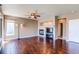 Cozy living room with a fireplace, large windows, and hardwood floors at 18995 E Bellisario Creek Pl, Parker, CO 80134