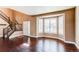 Bright living room featuring hardwood floors, a bay window with white shutters, and neutral paint at 18995 E Bellisario Creek Pl, Parker, CO 80134