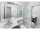Well-lit bathroom with a shower and frosted sliding glass doors, plus a large mirror and vanity sink at 4658 E 107Th Ave, Thornton, CO 80233