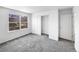 Well-lit bedroom with a large window, plush carpet, and closet for ample storage at 4658 E 107Th Ave, Thornton, CO 80233