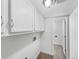 Functional laundry room featuring cabinets for storage and an adjoining utility room at 4658 E 107Th Ave, Thornton, CO 80233