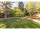 Landscaped backyard with lush lawn and mature trees at 545 S Harrison Ln, Denver, CO 80209