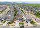 Drone eye view of neighborhood, homes with solar panels, and mountain backdrop at 9375 Joyce Way, Arvada, CO 80007