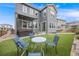 Backyard featuring artificial turf, hot tub, patio seating, and privacy fence at 9375 Joyce Way, Arvada, CO 80007