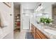 Bathroom featuring granite countertops, double sinks, shower, and shelving for storage at 9375 Joyce Way, Arvada, CO 80007
