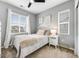 Bedroom featuring white-painted walls, a comfortable bed, and large windows at 9375 Joyce Way, Arvada, CO 80007