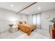 Bedroom with exposed ceiling beams, warm colors, and a cozy bed at 9375 Joyce Way, Arvada, CO 80007