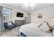 Cozy bedroom showcasing a modern light, TV, grey dresser, and comfortable seating at 9375 Joyce Way, Arvada, CO 80007