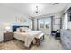Bright bedroom featuring a stylish light fixture, comfortable furniture, and large windows at 9375 Joyce Way, Arvada, CO 80007
