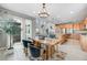 Inviting dining area with a wooden table, natural light, and access to the kitchen at 9375 Joyce Way, Arvada, CO 80007