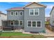 Back of home featuring manicured lawn, hot tub, patio seating, and a privacy fence at 9375 Joyce Way, Arvada, CO 80007