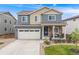 Attractive two-story house with a covered front porch, landscaped yard, and a convenient two-car garage at 9375 Joyce Way, Arvada, CO 80007