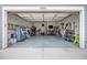 Spacious two car garage with high ceilings, ample storage, and ping pong table at 9375 Joyce Way, Arvada, CO 80007