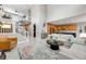 Bright, open-concept living room featuring high ceilings, modern decor, and a stylish staircase at 9375 Joyce Way, Arvada, CO 80007