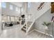 Inviting living room with high ceilings, fireplace, and open layout connected to the staircase at 9375 Joyce Way, Arvada, CO 80007