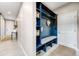 Mudroom featuring custom blue built-ins with a bench and storage shelves at 9375 Joyce Way, Arvada, CO 80007