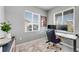 Well-lit office space featuring a modern desk, comfortable chair, and large windows overlooking the neighborhood at 9375 Joyce Way, Arvada, CO 80007