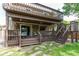 Two-story deck featuring multiple seating areas, a staircase to the yard, and stylish decor for outdoor enjoyment at 6687 Devinney Ct, Arvada, CO 80004