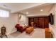 Finished basement featuring built-in bookshelves, comfy seating, and a warm, inviting atmosphere at 6687 Devinney Ct, Arvada, CO 80004
