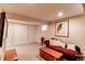 Basement featuring a comfortable sofa, storage, and classic design elements for relaxed living at 6687 Devinney Ct, Arvada, CO 80004