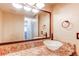 Bathroom featuring a stylish bowl sink, elegant mirror, and updated fixtures for a contemporary look at 6687 Devinney Ct, Arvada, CO 80004