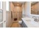 Renovated bathroom with white tile, glass shower door, and modern vanity at 6687 Devinney Ct, Arvada, CO 80004