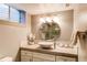 Bathroom featuring a modern vanity, elegant mirror, and updated lighting for a serene ambiance at 6687 Devinney Ct, Arvada, CO 80004
