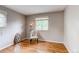 Bright bedroom with hardwood floors, a comfortable chair, and a window providing natural light at 6687 Devinney Ct, Arvada, CO 80004
