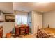 Bedroom with a vintage wooden desk, comfortable chair, and natural light for a peaceful retreat at 6687 Devinney Ct, Arvada, CO 80004