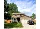 Charming two-story home features a manicured lawn, two car garage, and beautiful landscaping at 6687 Devinney Ct, Arvada, CO 80004