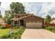 Inviting home exterior with a well-manicured lawn, flower beds, and a two-car garage, creating curb appeal at 6687 Devinney Ct, Arvada, CO 80004