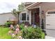 Charming home featuring a bay window, stone accents, and a beautifully landscaped front yard with colorful irises at 6687 Devinney Ct, Arvada, CO 80004