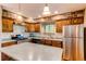 Bright kitchen features stainless appliances, stone backsplash, and wooden cabinetry at 6687 Devinney Ct, Arvada, CO 80004