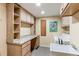 Functional laundry room with ample storage, counter space, and modern appliances for efficient chores at 6687 Devinney Ct, Arvada, CO 80004