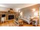 Living room features a stone fireplace, hardwood floors, and neutral decor at 6687 Devinney Ct, Arvada, CO 80004