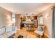 Open-concept living room and kitchen with hardwood floors and cozy furnishings at 6687 Devinney Ct, Arvada, CO 80004