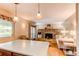 Open kitchen and living area with stone fireplace and hardwood floors at 6687 Devinney Ct, Arvada, CO 80004