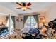 Main bedroom with ceiling fan and a sliding glass door to balcony at 6687 Devinney Ct, Arvada, CO 80004
