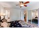 Main bedroom with mirrored closet doors and a door to the bathroom at 6687 Devinney Ct, Arvada, CO 80004