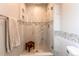 Elegant glass shower featuring beautiful tile work, built-in shelves, and a convenient wooden bench at 6687 Devinney Ct, Arvada, CO 80004