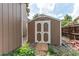 Well-maintained storage shed with double doors, offering ample space for gardening tools and outdoor equipment at 6687 Devinney Ct, Arvada, CO 80004