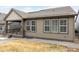 Back exterior with a covered porch and well-lit windows, overlooking the backyard at 8175 Sewanee Peak St, Littleton, CO 80125