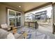 Covered porch with sliding glass door access, overlooking a backyard with privacy fencing at 8175 Sewanee Peak St, Littleton, CO 80125