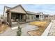 Backyard view featuring a covered patio and well-maintained landscaping and gravel at 8175 Sewanee Peak St, Littleton, CO 80125