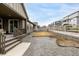 Gravel backyard featuring a covered patio area and view of surrounding neighborhood homes at 8175 Sewanee Peak St, Littleton, CO 80125