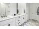 Modern bathroom featuring a double sink vanity, granite countertops, and stylish fixtures at 8175 Sewanee Peak St, Littleton, CO 80125