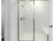 Bathroom featuring glass enclosed shower with white subway tile and a built-in bench at 8175 Sewanee Peak St, Littleton, CO 80125